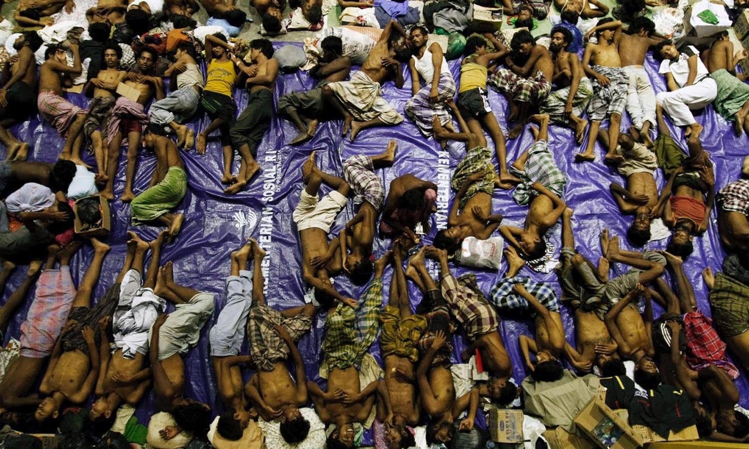 Migrants rest inside a shelter after being rescued from boats — Reuters